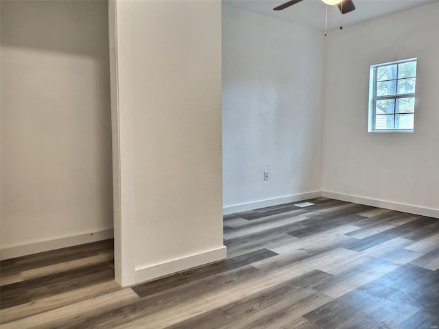 empty room with dark hardwood / wood-style floors and ceiling fan