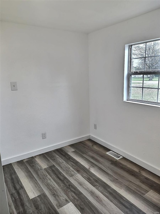 empty room featuring dark hardwood / wood-style flooring