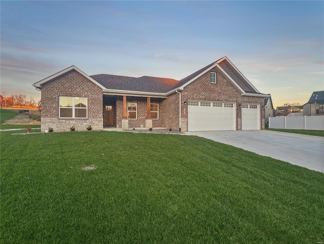 view of front of property featuring a garage and a yard