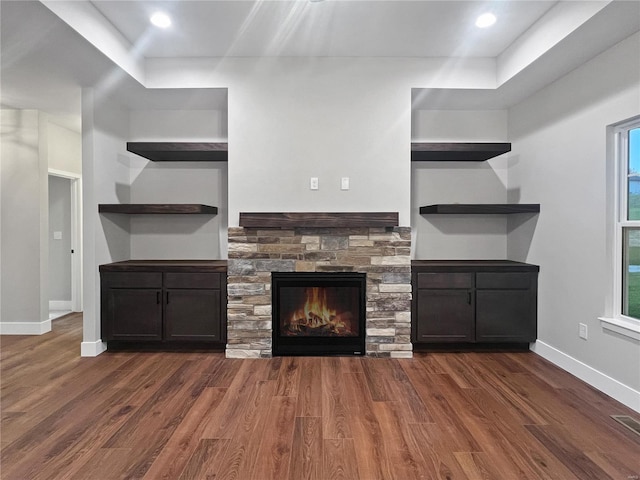 kitchen featuring a healthy amount of sunlight, dark hardwood / wood-style flooring, and a fireplace