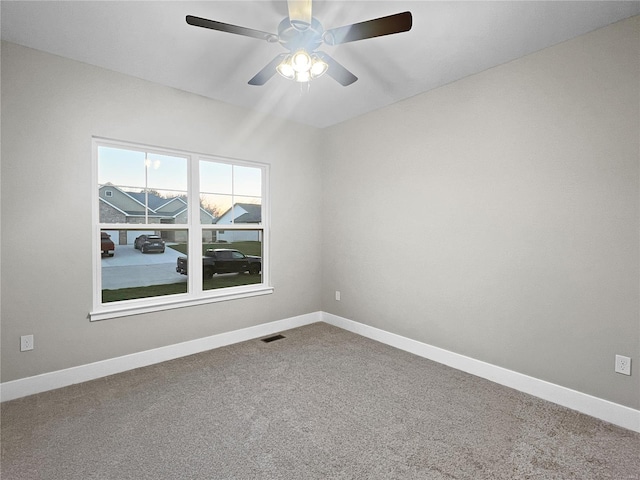 spare room with carpet and ceiling fan