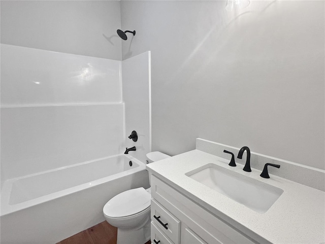 full bathroom with hardwood / wood-style floors, vanity, tub / shower combination, and toilet