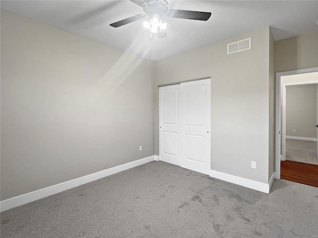 unfurnished bedroom featuring carpet, a closet, and ceiling fan