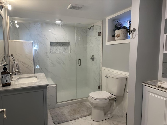 bathroom with vanity, toilet, and walk in shower