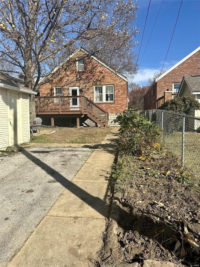 rear view of house featuring a deck