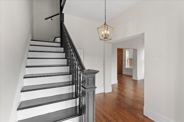 stairs featuring a chandelier and hardwood / wood-style flooring