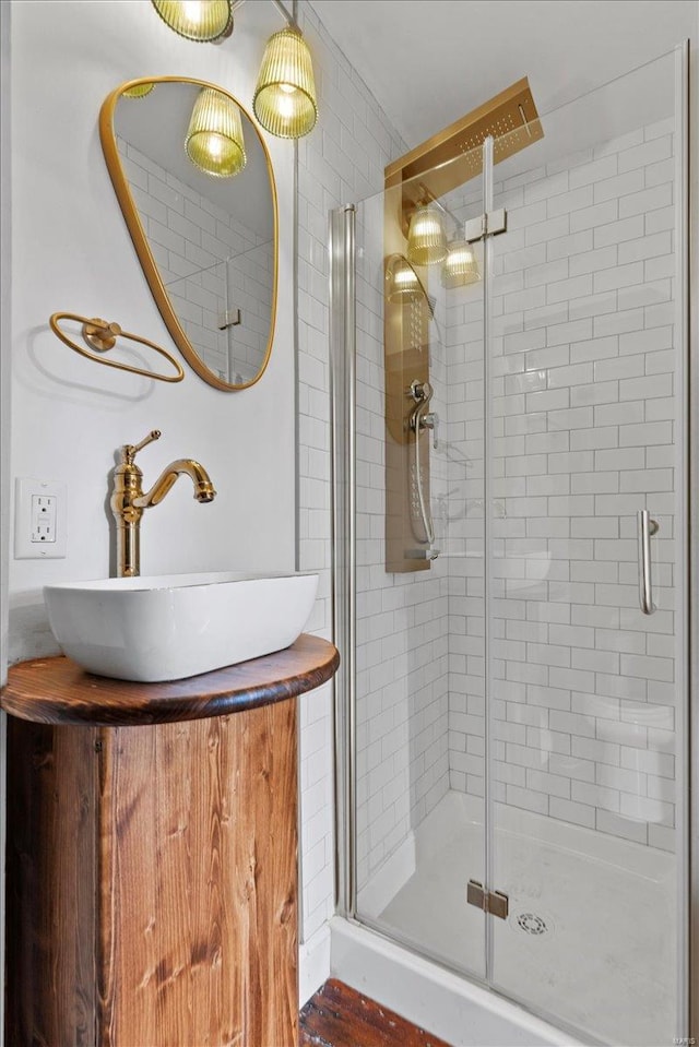 bathroom featuring vanity, hardwood / wood-style flooring, and an enclosed shower