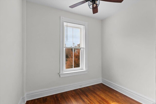 unfurnished room with dark hardwood / wood-style floors and ceiling fan