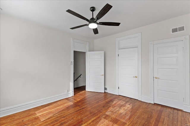 unfurnished bedroom with hardwood / wood-style flooring and ceiling fan