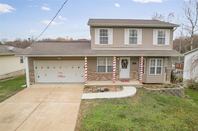 view of front of home featuring a front lawn, a porch, and a garage