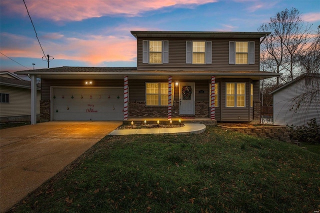 view of front of property featuring a garage and a yard