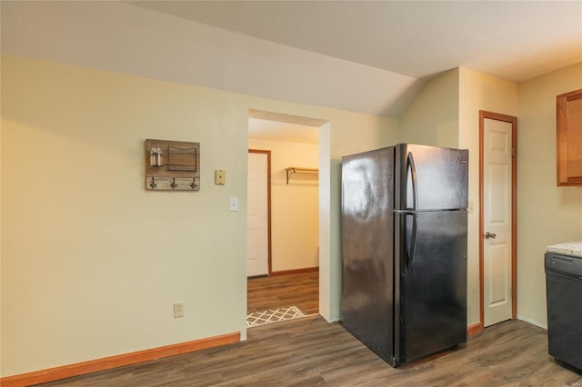 kitchen with black appliances, dark hardwood / wood-style flooring, and lofted ceiling