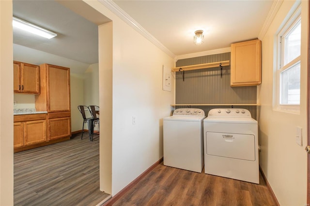 washroom featuring cabinets, dark hardwood / wood-style flooring, washer and clothes dryer, and ornamental molding