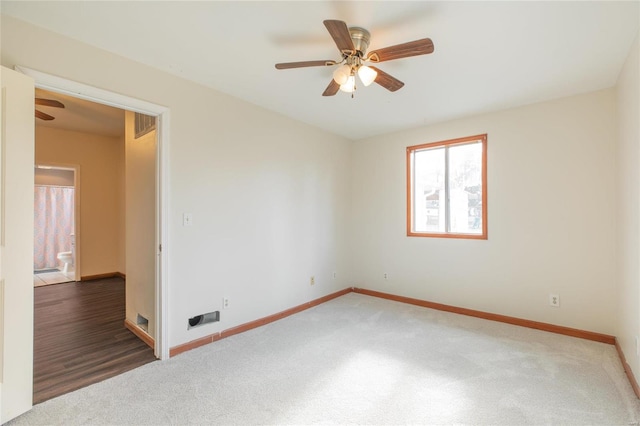 spare room with ceiling fan and dark wood-type flooring