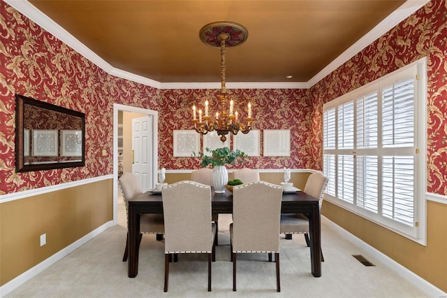 carpeted dining room featuring a notable chandelier, crown molding, and a wealth of natural light