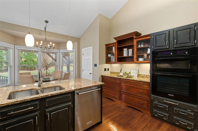 kitchen with dishwasher, light stone counters, hanging light fixtures, and double oven