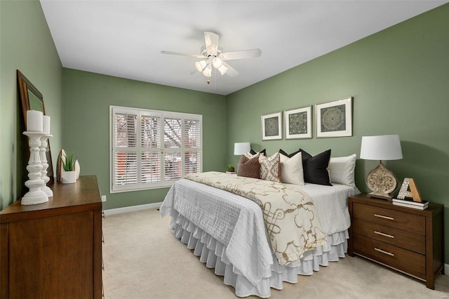 bedroom featuring light colored carpet and ceiling fan