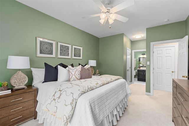 carpeted bedroom with connected bathroom and ceiling fan