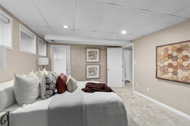 carpeted bedroom featuring a paneled ceiling