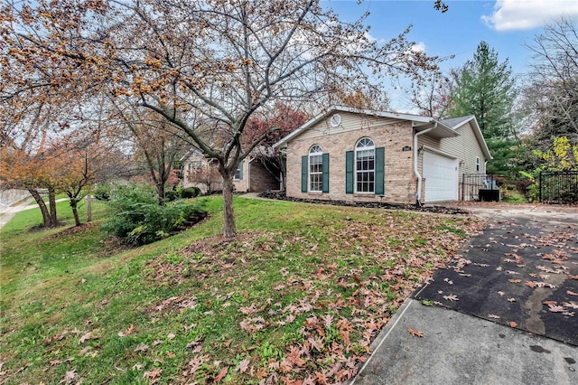 view of front of house with a garage and a front lawn