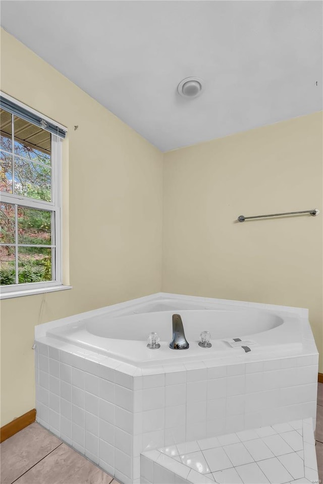 bathroom featuring tile patterned floors and tiled tub