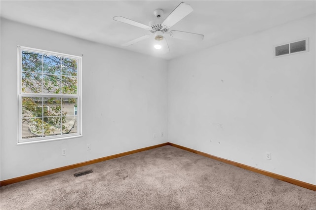 unfurnished room featuring ceiling fan and carpet floors