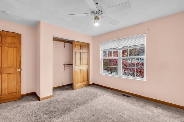 unfurnished bedroom with carpet flooring, ceiling fan, and a closet