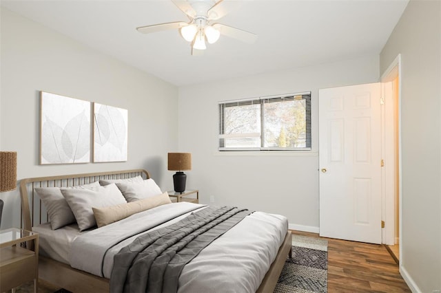 bedroom with dark hardwood / wood-style floors and ceiling fan