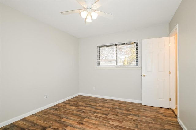 spare room with ceiling fan and dark wood-type flooring