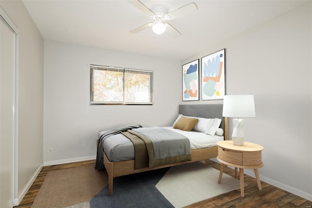 bedroom with ceiling fan and dark wood-type flooring