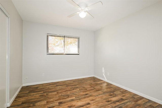 spare room with ceiling fan and dark hardwood / wood-style flooring