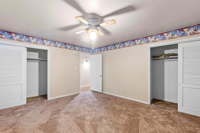 unfurnished bedroom featuring multiple closets, ceiling fan, and carpet