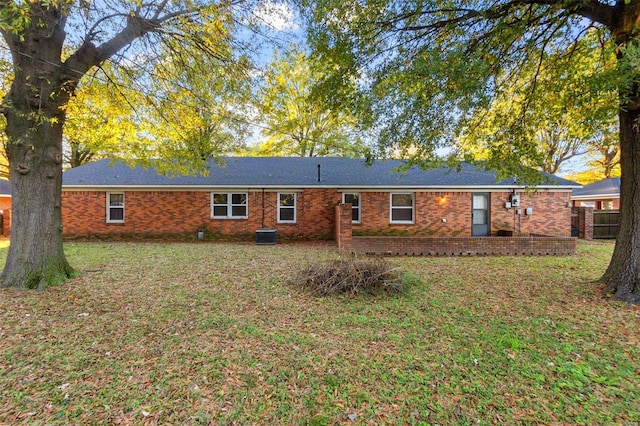 rear view of property with a lawn