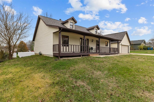 view of front of property featuring a front yard, a garage, and covered porch