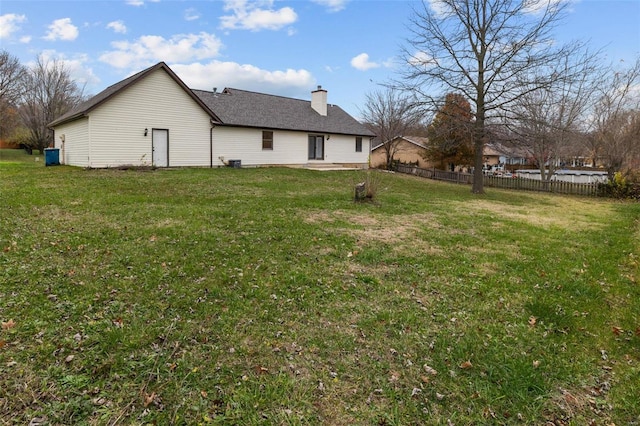 view of side of home with a yard