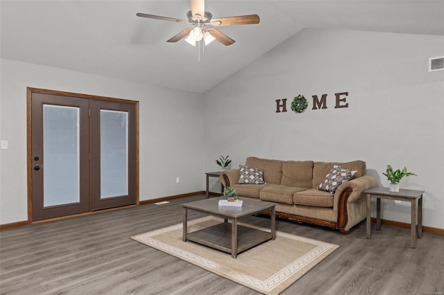 living room with hardwood / wood-style flooring, ceiling fan, and lofted ceiling