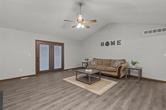 living room with ceiling fan, wood-type flooring, and lofted ceiling