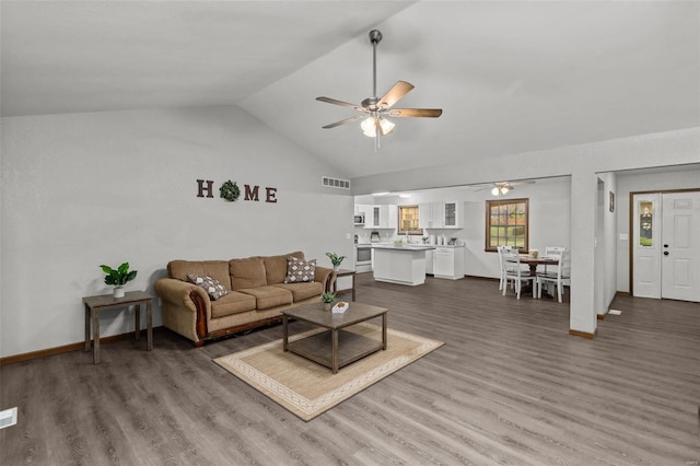 living room with dark hardwood / wood-style floors, ceiling fan, and lofted ceiling