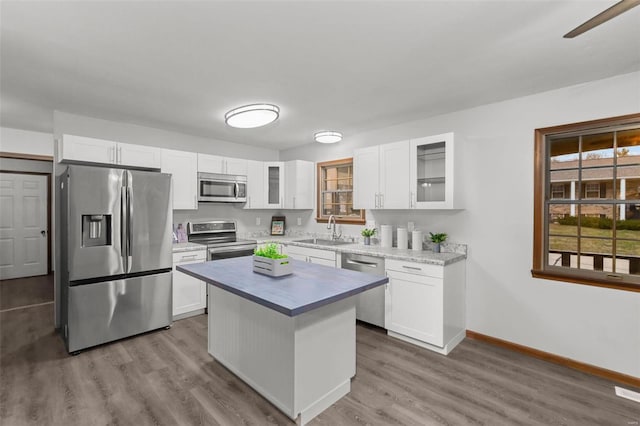 kitchen with white cabinets, a kitchen island, and appliances with stainless steel finishes