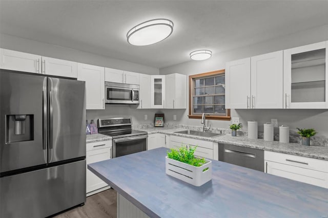 kitchen with white cabinets, sink, and stainless steel appliances