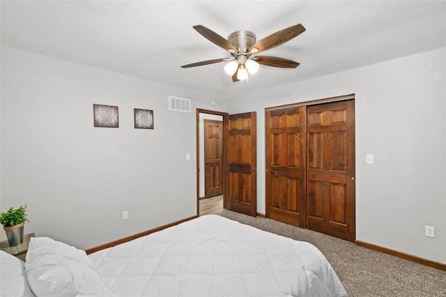 carpeted bedroom with a closet and ceiling fan