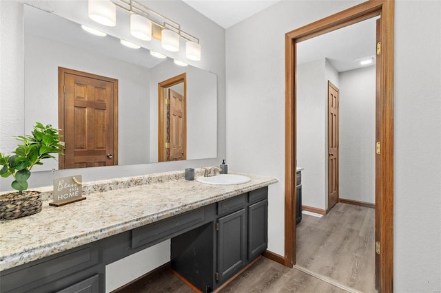 bathroom with vanity and wood-type flooring