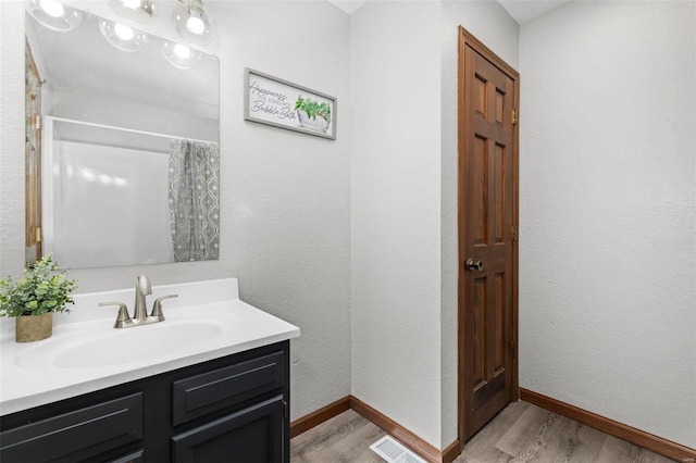 bathroom featuring hardwood / wood-style floors and vanity