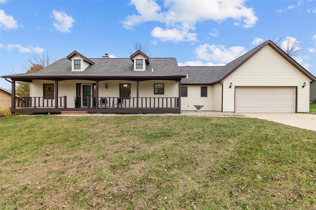 view of front of house with a front yard, a garage, and covered porch