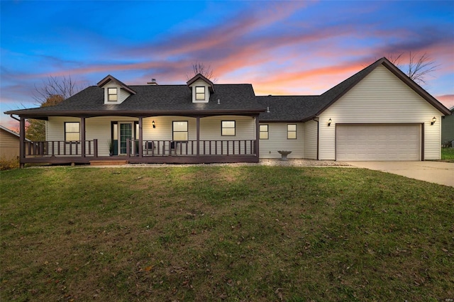 view of front of home with a garage and a lawn