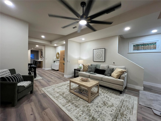 living room featuring ceiling fan and hardwood / wood-style flooring