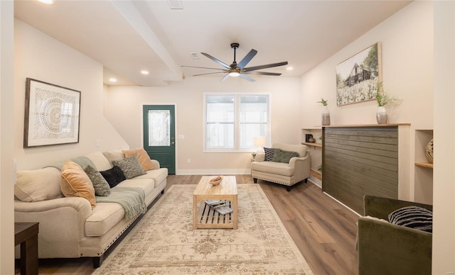 living room featuring hardwood / wood-style flooring and ceiling fan