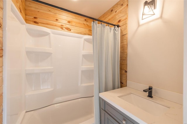 bathroom with vanity and wood walls