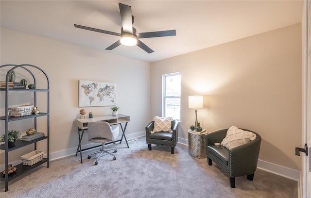 carpeted office space featuring ceiling fan