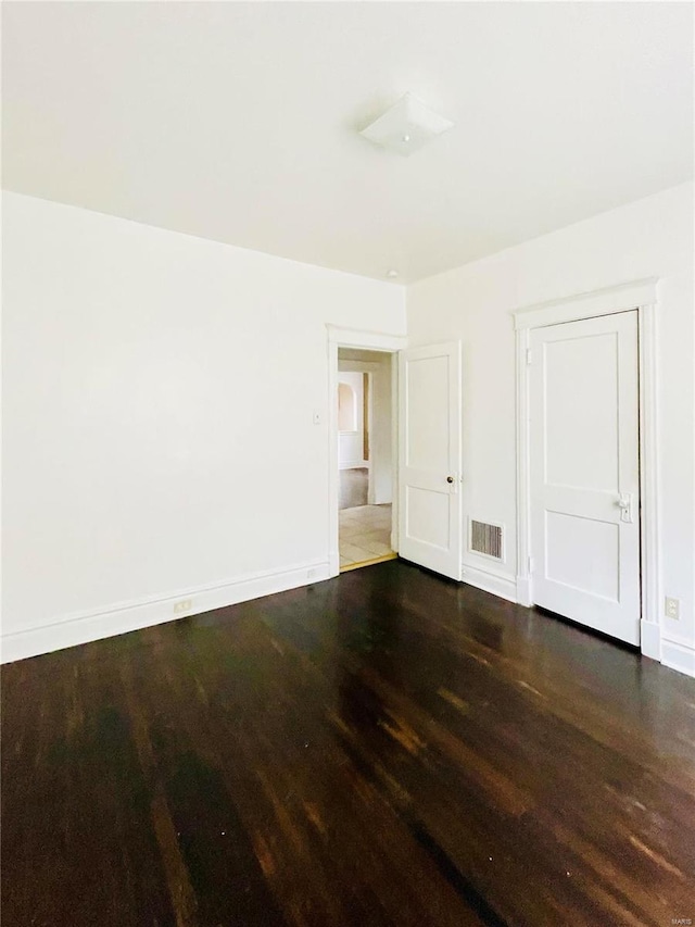 unfurnished bedroom featuring dark wood-type flooring